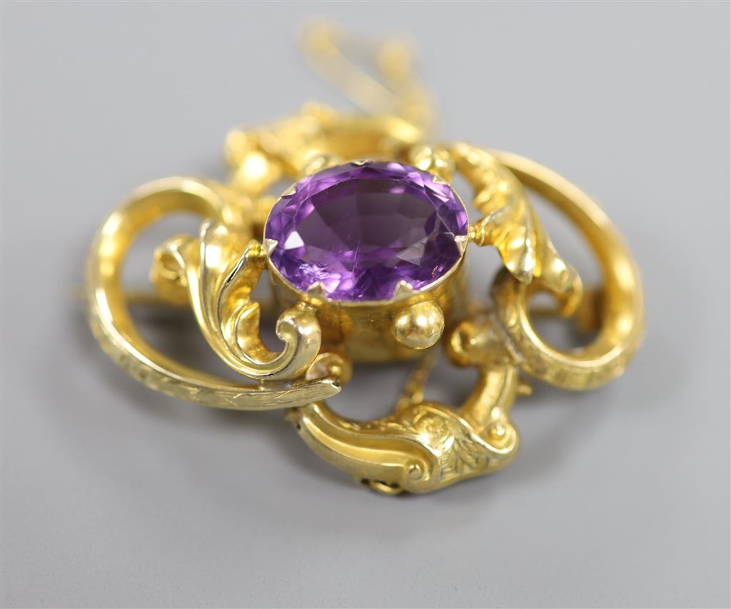 A Victorian yellow metal and amethyst set scroll brooch & 2 others.